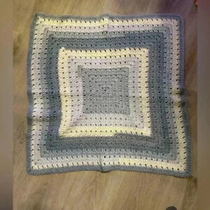 Handmade crocheted baby afghan blanket in grays with blue hues & cream